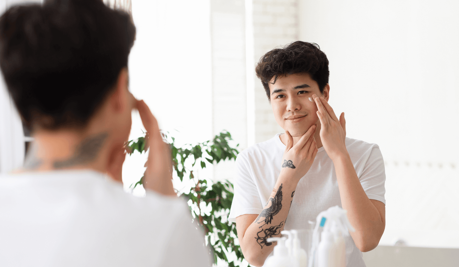 A man applying Korean cosmetics cream onto his face