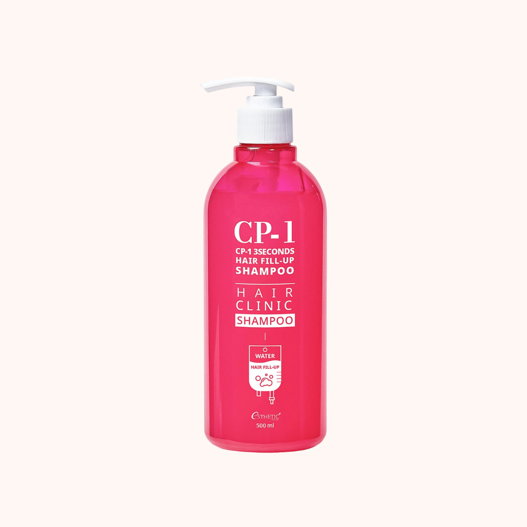 Pink shampoo bottle with pump on a white background