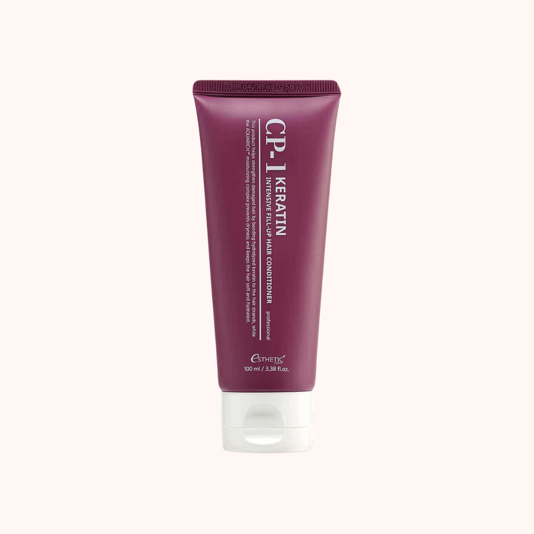 A tube of Everang CP.1 Keratin Hair Conditioner in a deep plum purple color with a white cap, centered on a light cream background.