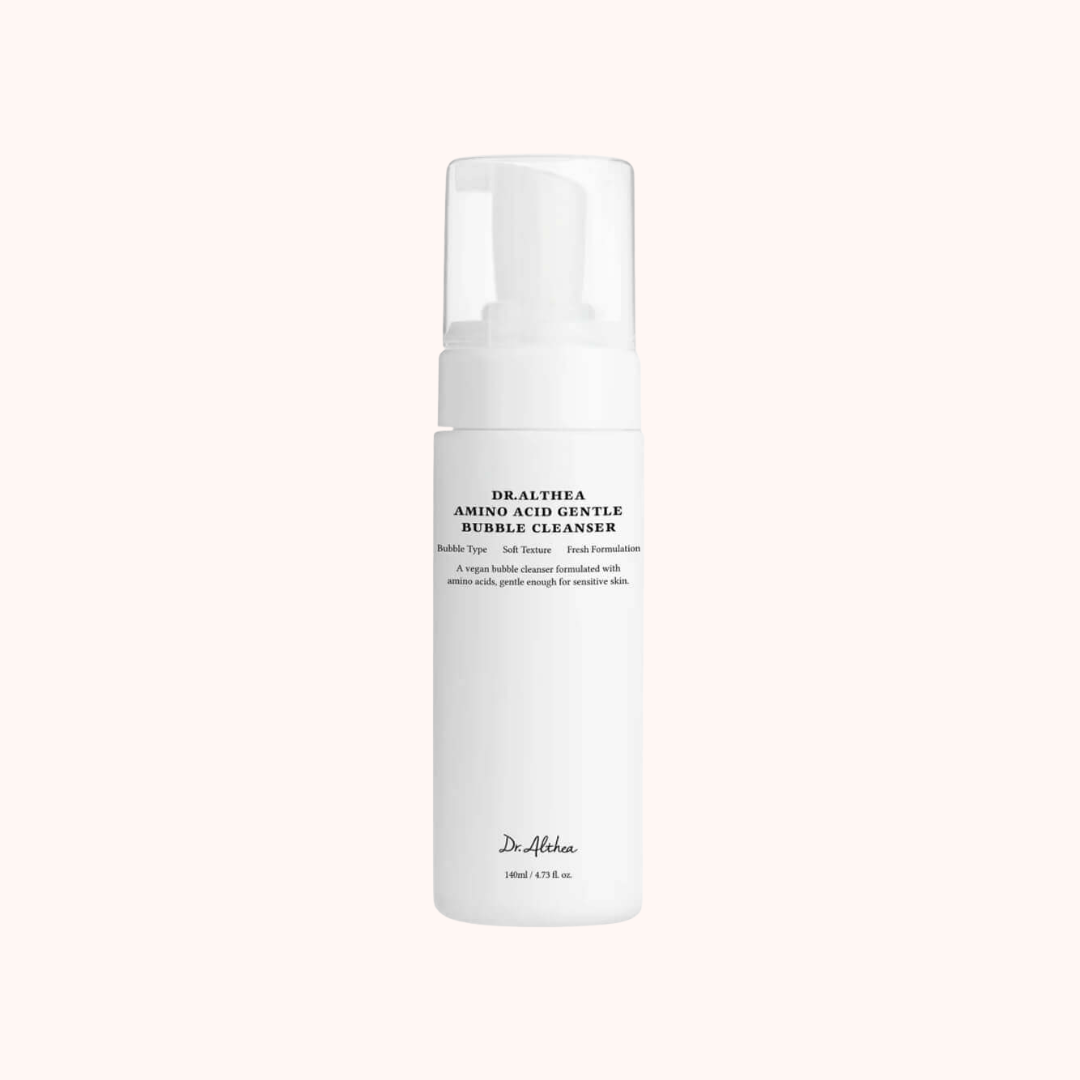 A white pump bottle of Dr. Althaea Amino Acid Gentle Bubble Cleanser, shown against a solid pale pink background.