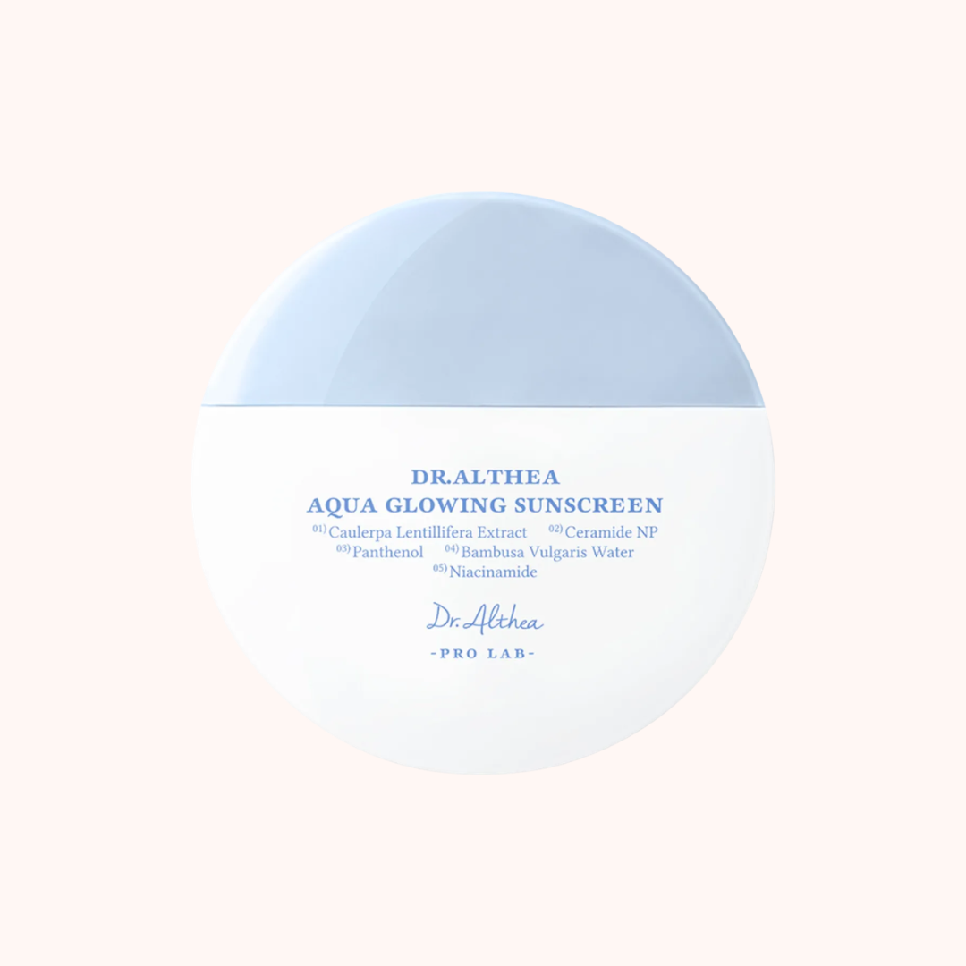 Dr. Althea Aqua Glowing Sunscreen container on a light pink background