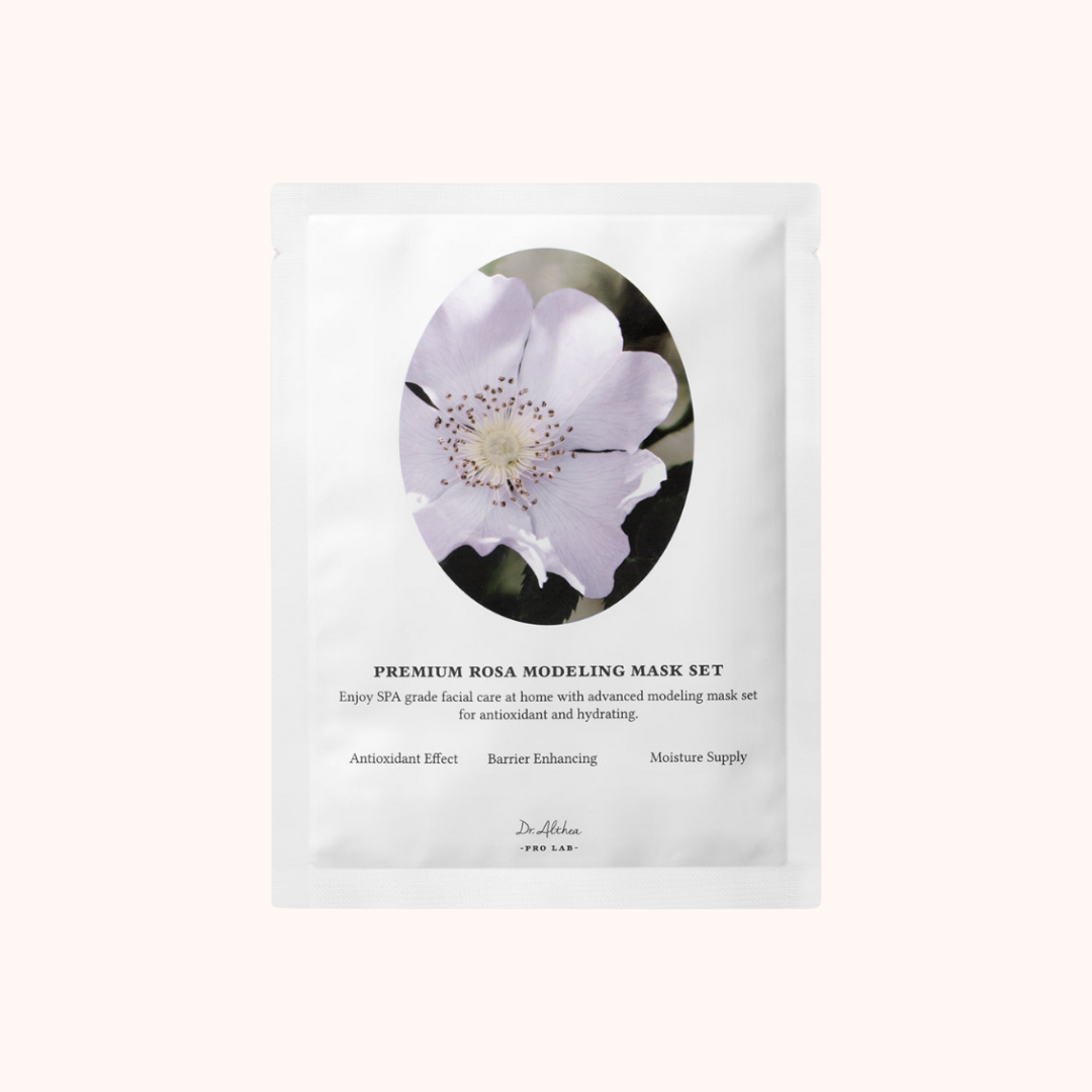 A packaged Premium Rosa Modeling Mask by Dr. Althea, featuring an image of a pink rose on the front, with text detailing the product as a 25g facial mask with alginate and rosehip extract.