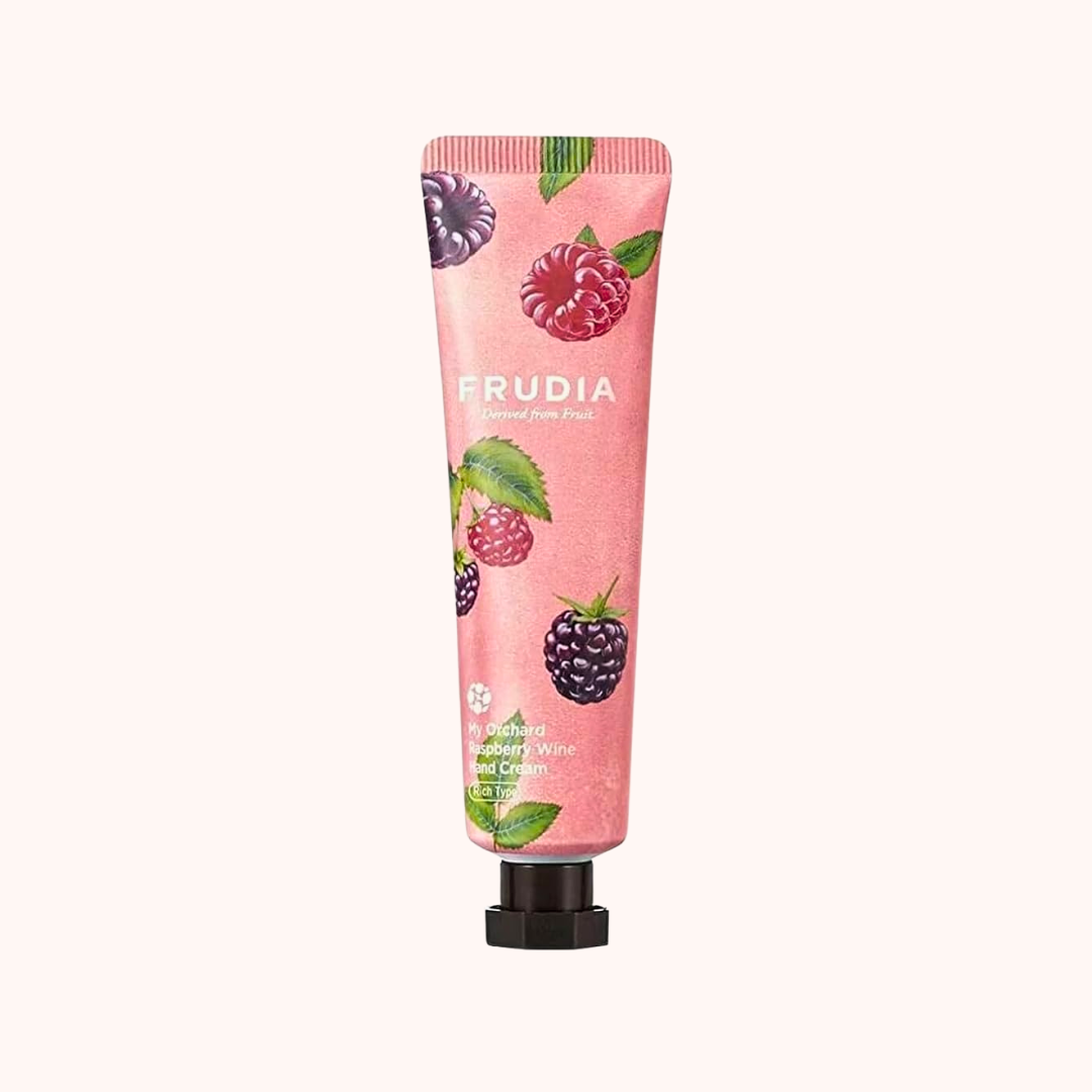 Pink hand cream tube with berry design and &