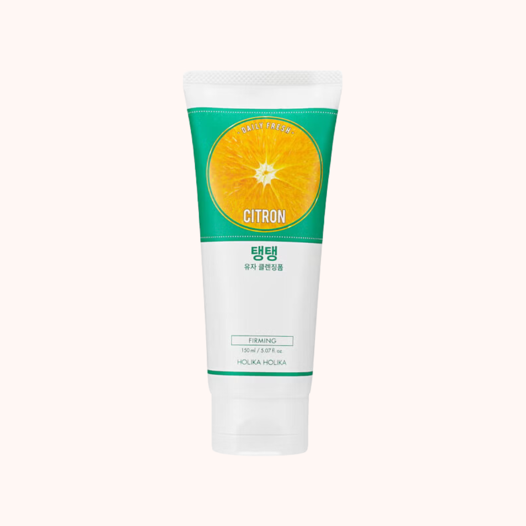 A tube of Holika Holika Daily Fresh Citron Cleansing Foam with a green and white label, featuring an image of a slice of orange.