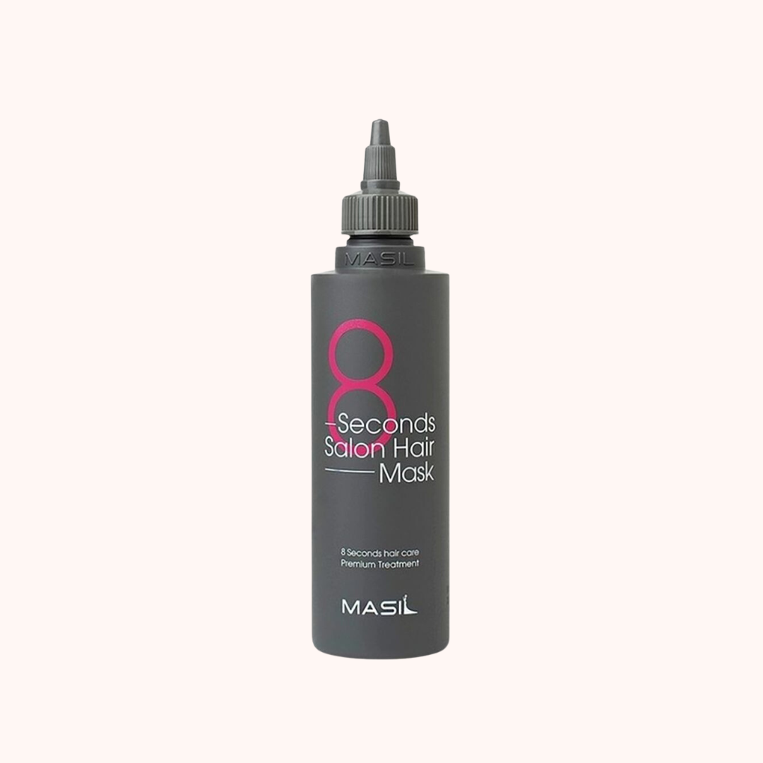 A bottle of MASIL 8 Seconds Salon Hair Mask, primarily in a black and gray color scheme with product details.