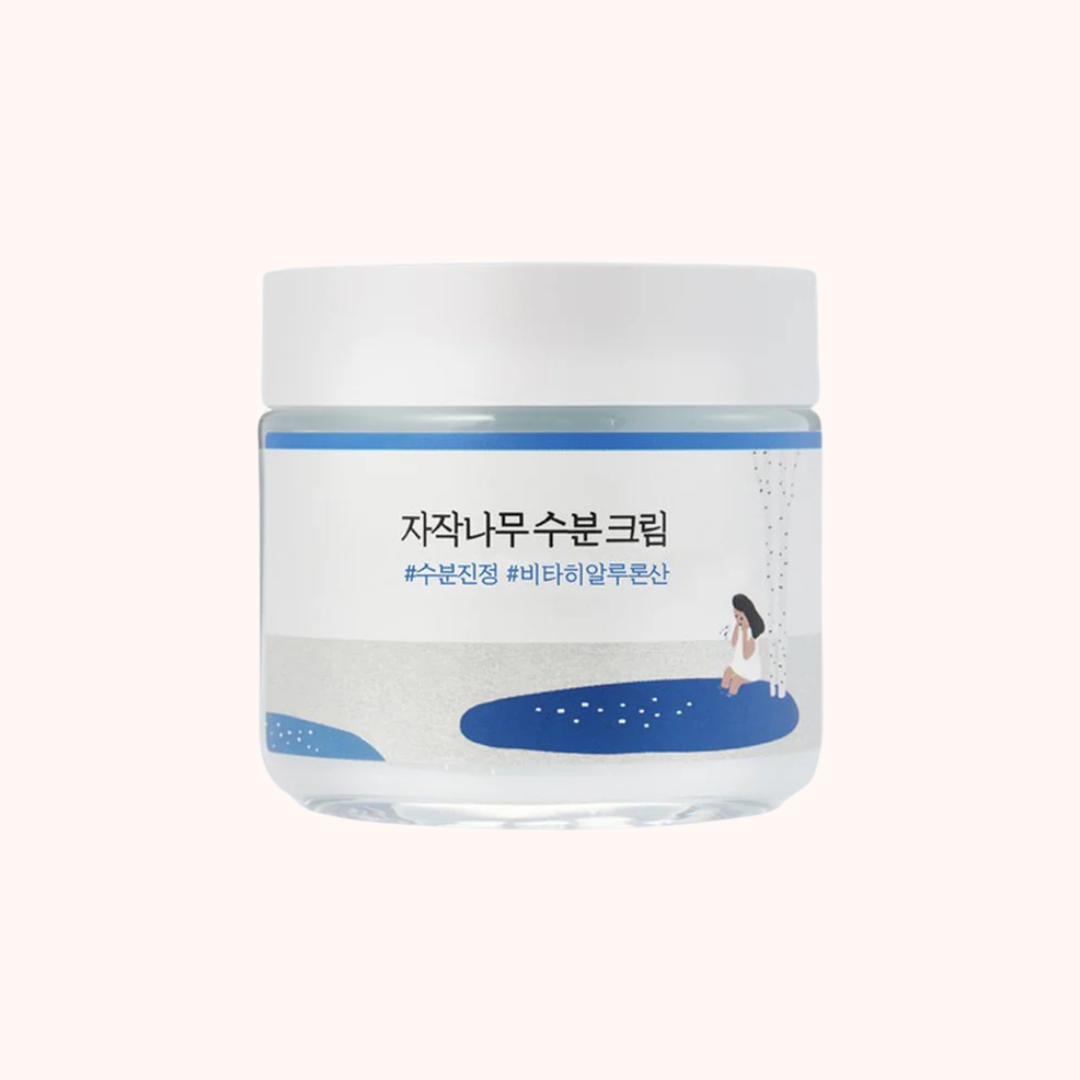 Skincare cream jar with Korean text on a white background