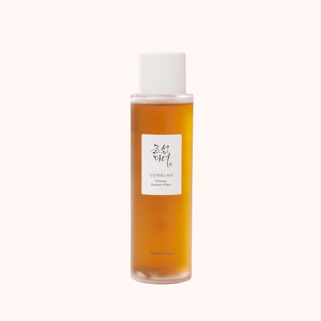 A clear glass bottle with a white cap containing a brown liquid, labeled &