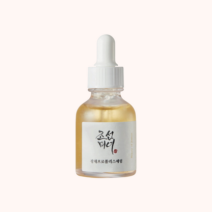 Bottle of skincare serum with a dropper on a white background