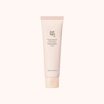 Beauty of Joseon Revive Flaming Moisturizer Glowing Cream in a pale pink squeeze tube, centered on a very light cream background.