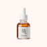 Bottle of skincare serum with a dropper on a white background