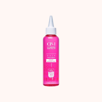 Pink hair treatment bottle with white cap on a white background