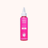 Pink hair treatment bottle with white cap on a white background