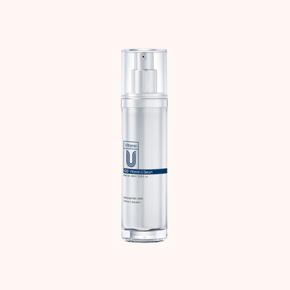 Skincare serum bottle with pump on a white background