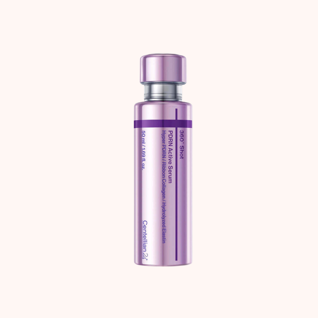 A single cylindrical cosmetic bottle with a metallic lavender-purple cap and matching purple label accents, centered on a very light warm beige background. The bottle appears to be a skincare or serum container with printed text on the front.