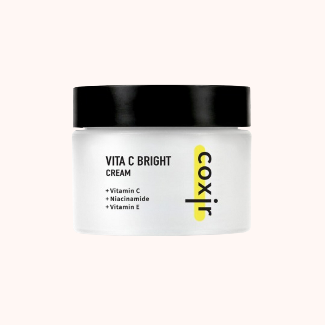 A jar of Coxir Vita C Bright Facial Moisturizing Cream with clear labeling of its main active ingredients: Vitamin C, Niacinamide, and Vitamin E.