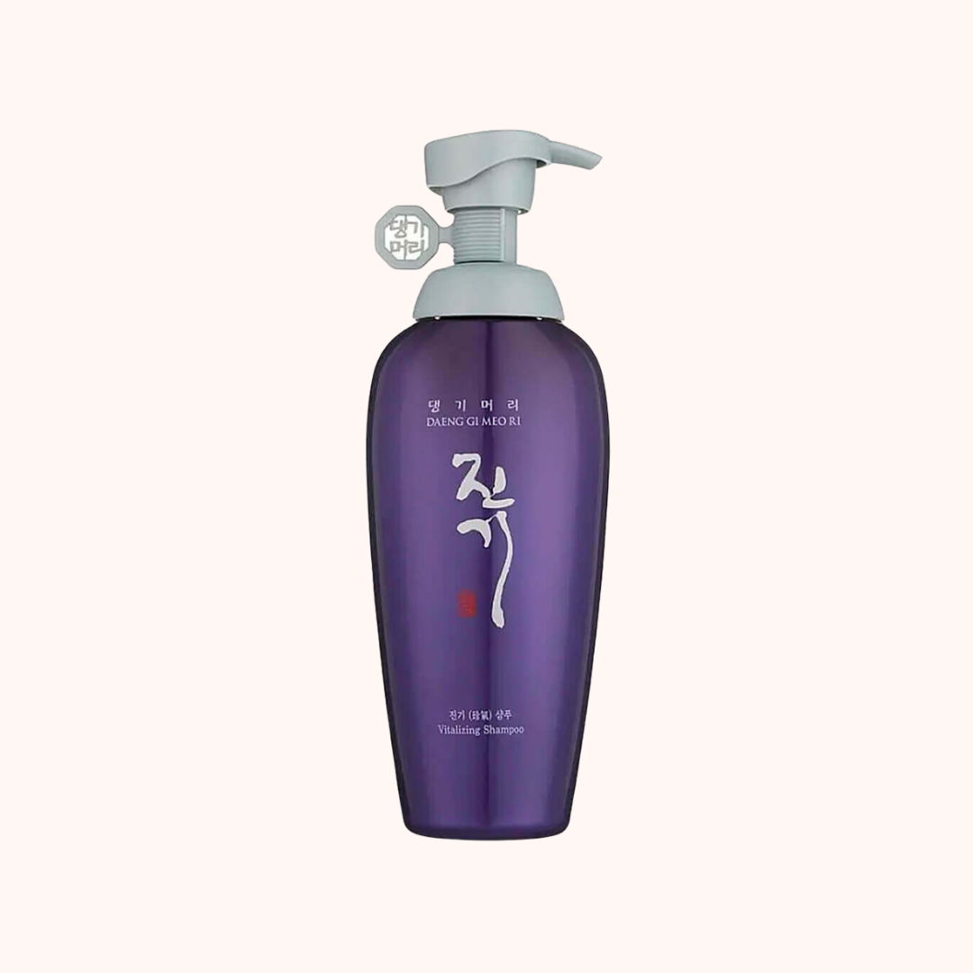 Purple shampoo bottle with pump on a white background
