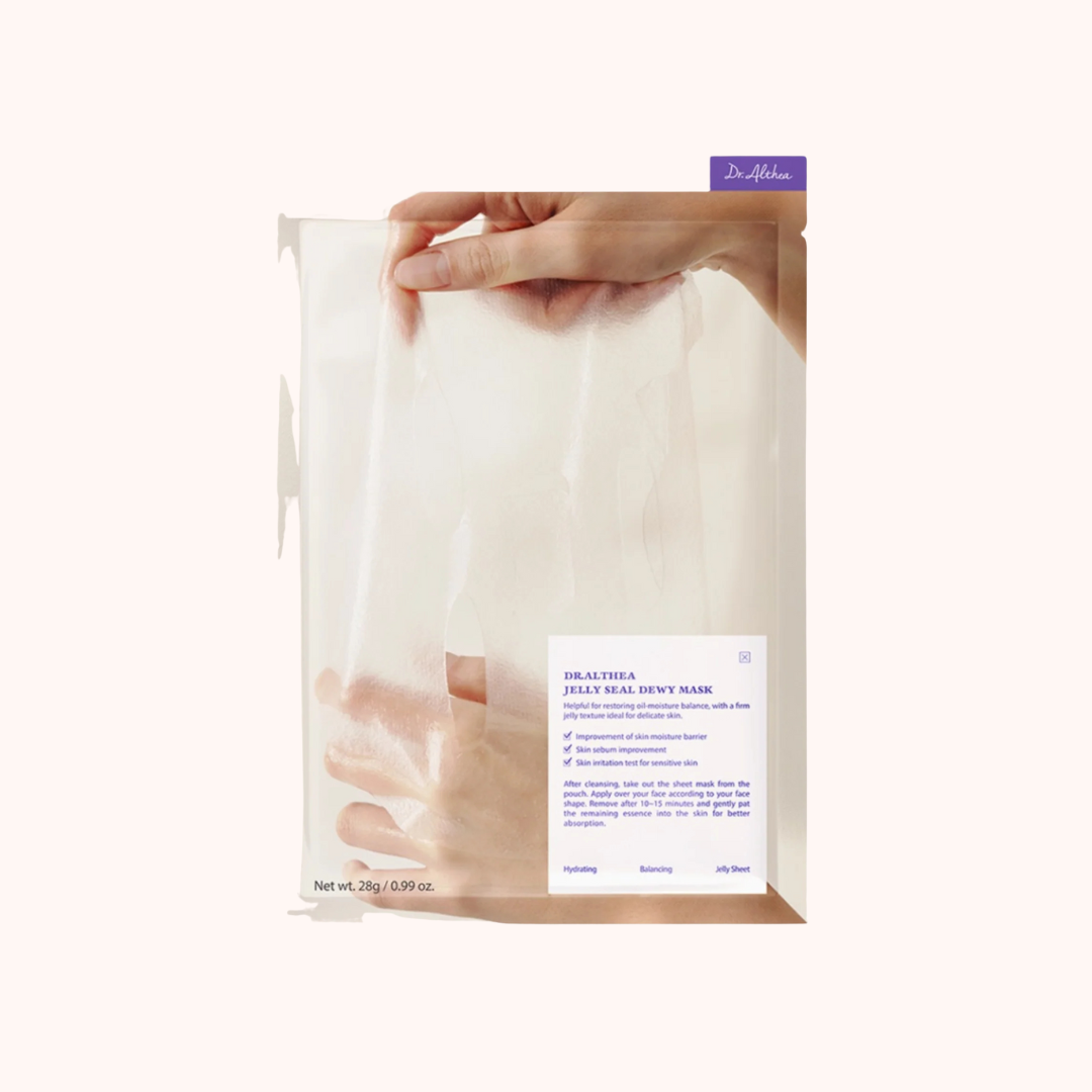 Dr. Dennis Gross Skincare jelly dual dewy mask packaging held by a hand on a white background