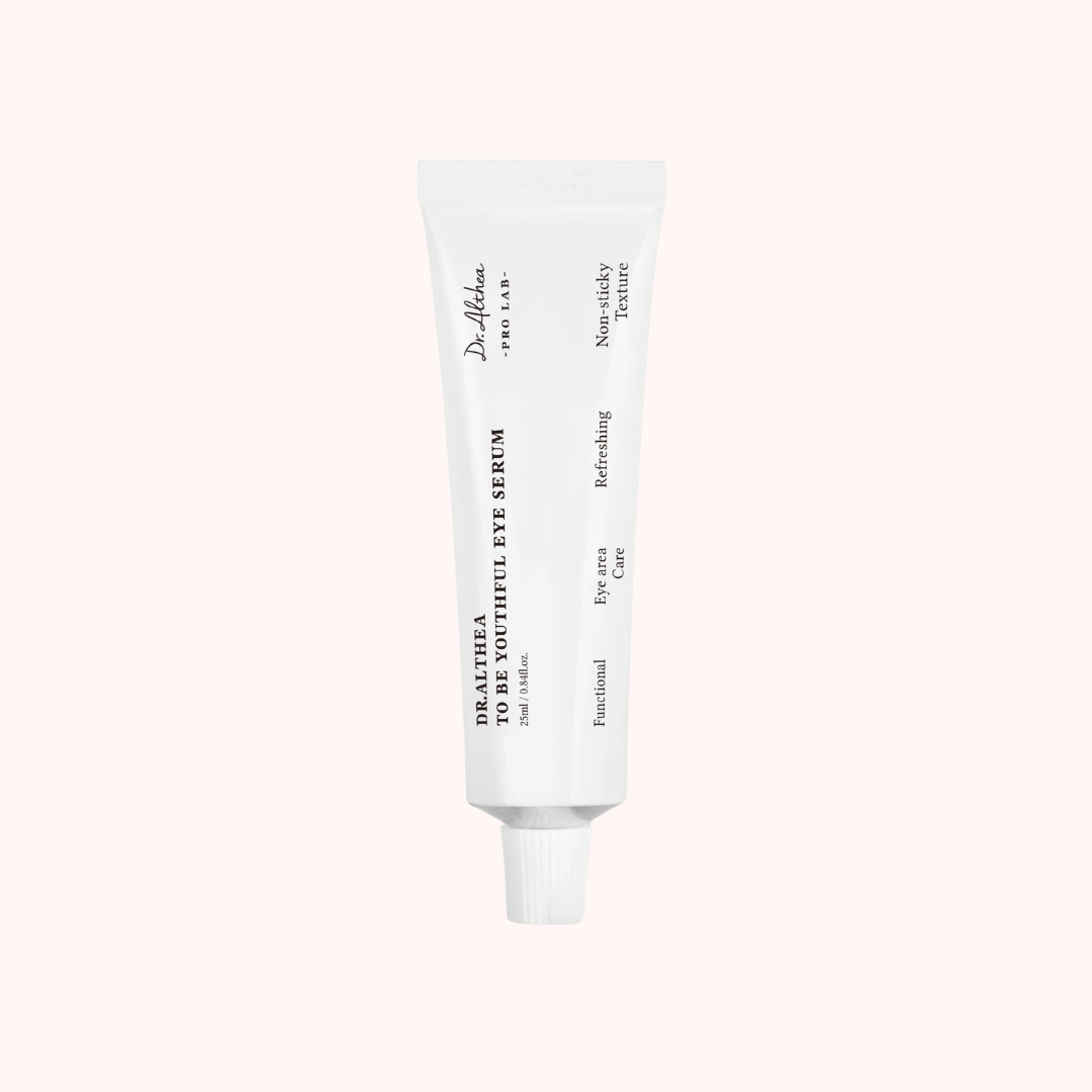 White skincare serum tube on a light beige background