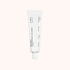 White skincare serum tube on a light beige background