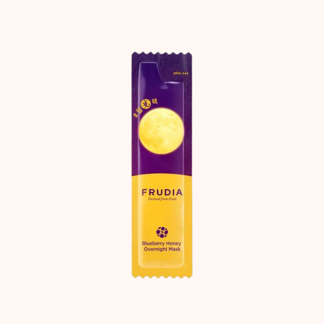 Packaging of Frudia Blueberry Honey Overnight Mask, predominantly purple and yellow with text and branding visible.