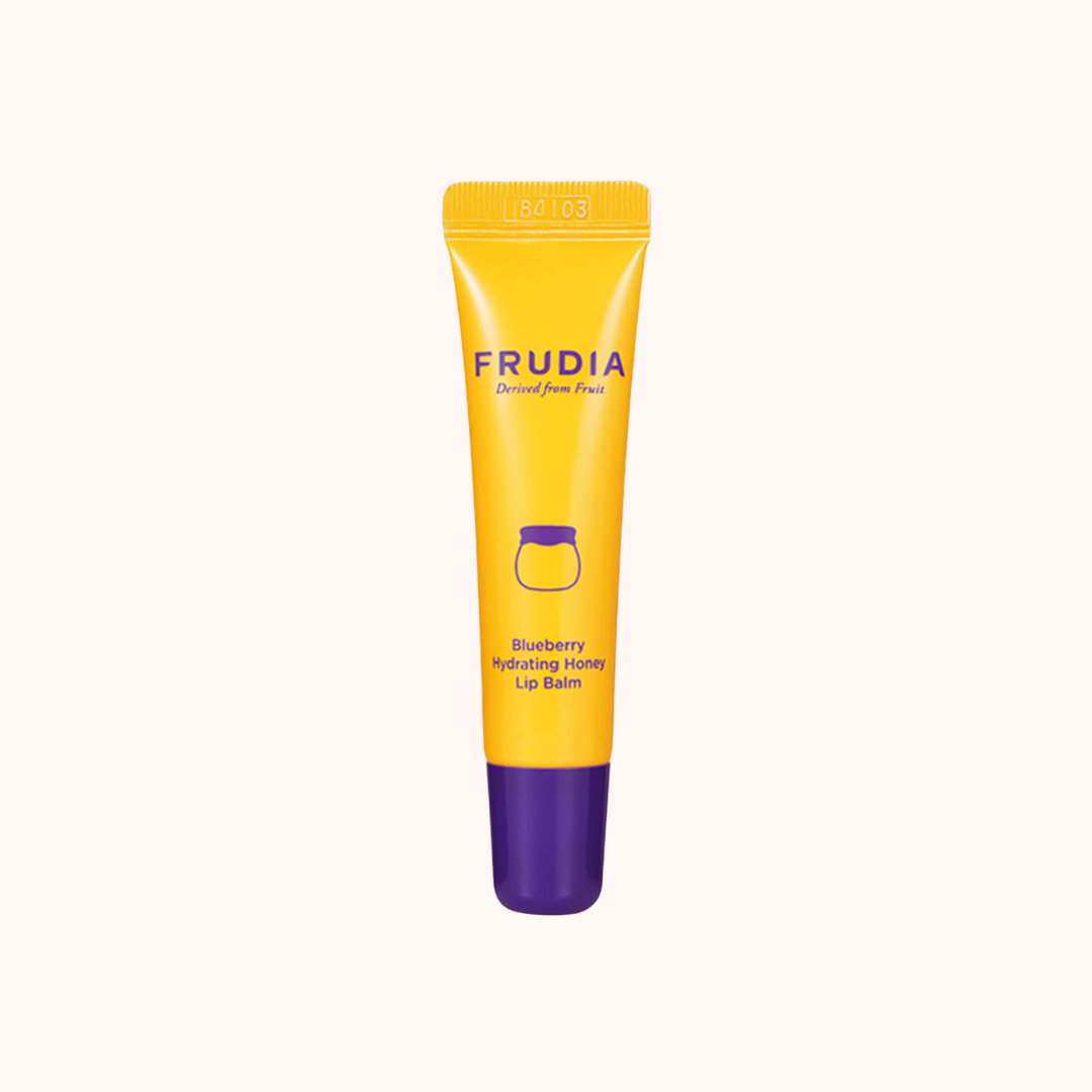 Yellow and purple lip balm tube with Frudia branding on a white background