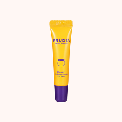 Yellow and purple lip balm tube with Frudia branding on a white background