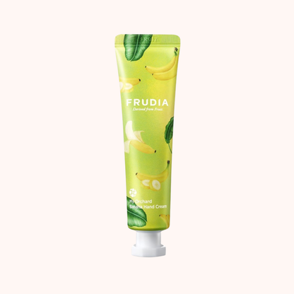 Green hand cream tube with Frudia branding on a white background