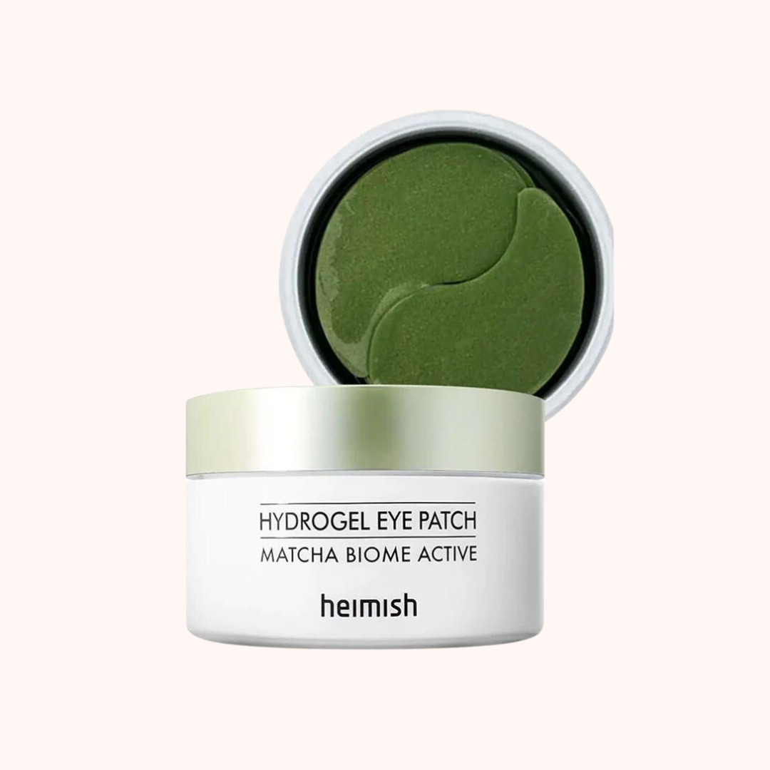 A green-colored hydrogel eye patch by Heimish, contained in a white jar with a green lid, labeled as &