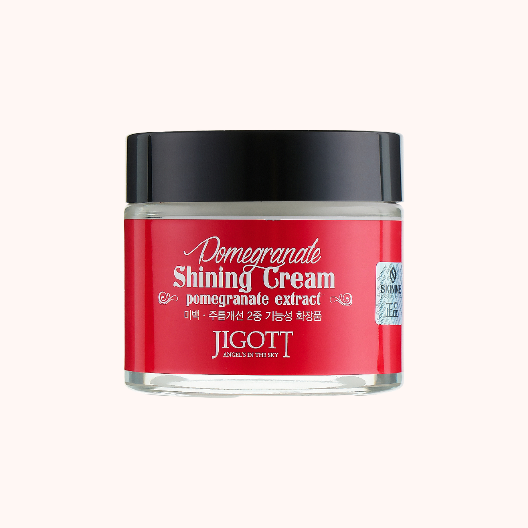 Red jar of Jigott Pomegranate Shining Cream on a white background