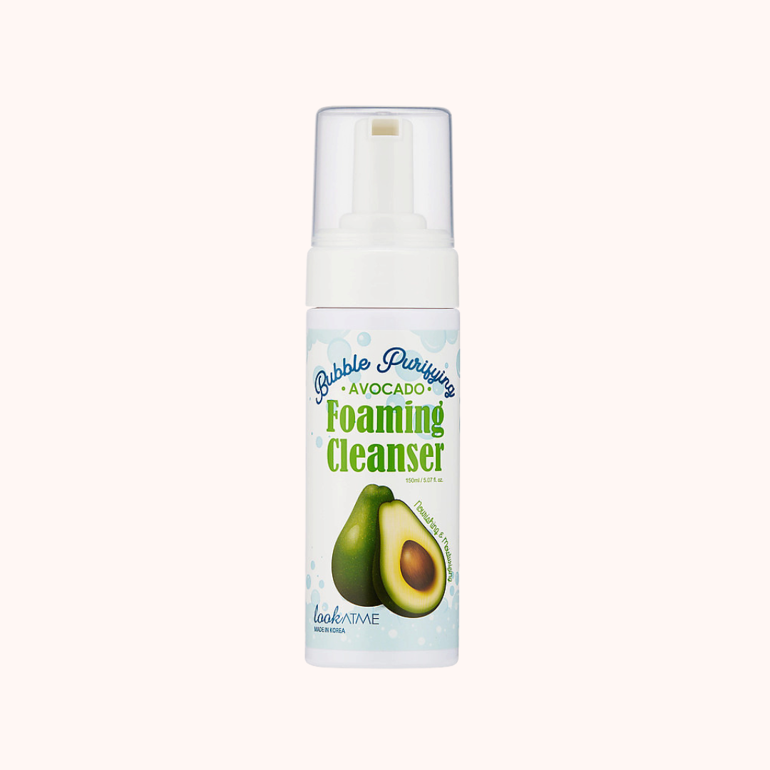 A bottle of Look At Me Bubble Purifying Foaming Cleanser with avocado extract. The packaging is predominantly white with a label featuring an avocado and text detailing the product&
