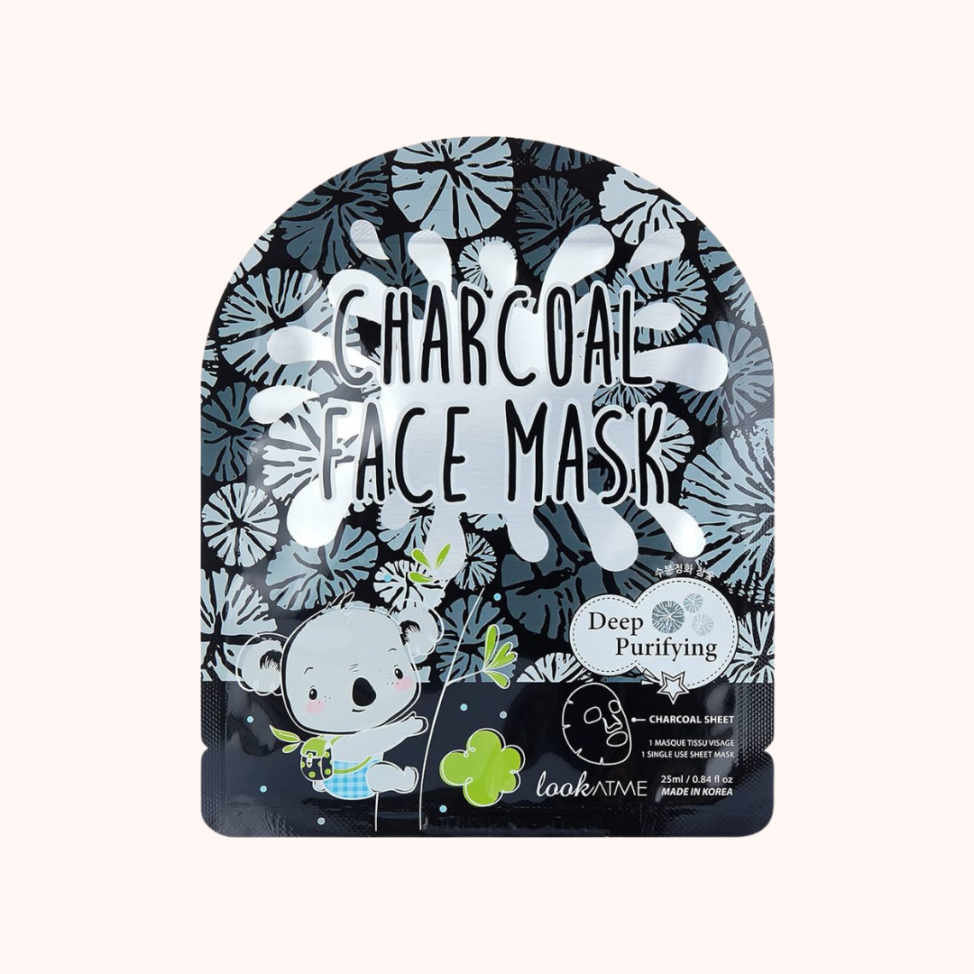 Packaging of Look At Me Charcoal Face Sheet Mask featuring a koala character, text, and floral patterns predominantly in black, blue, and white colors.