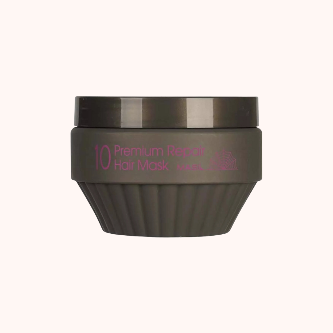 Dark green hair mask container with pink text on a white background