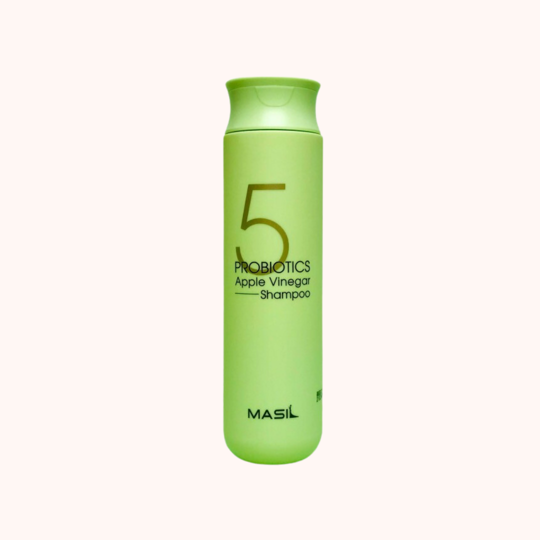 A green bottle of MASIL 5 Probiotics Apple Vinegar Shampoo, 300ml, with white and black text detailing the product name and features.