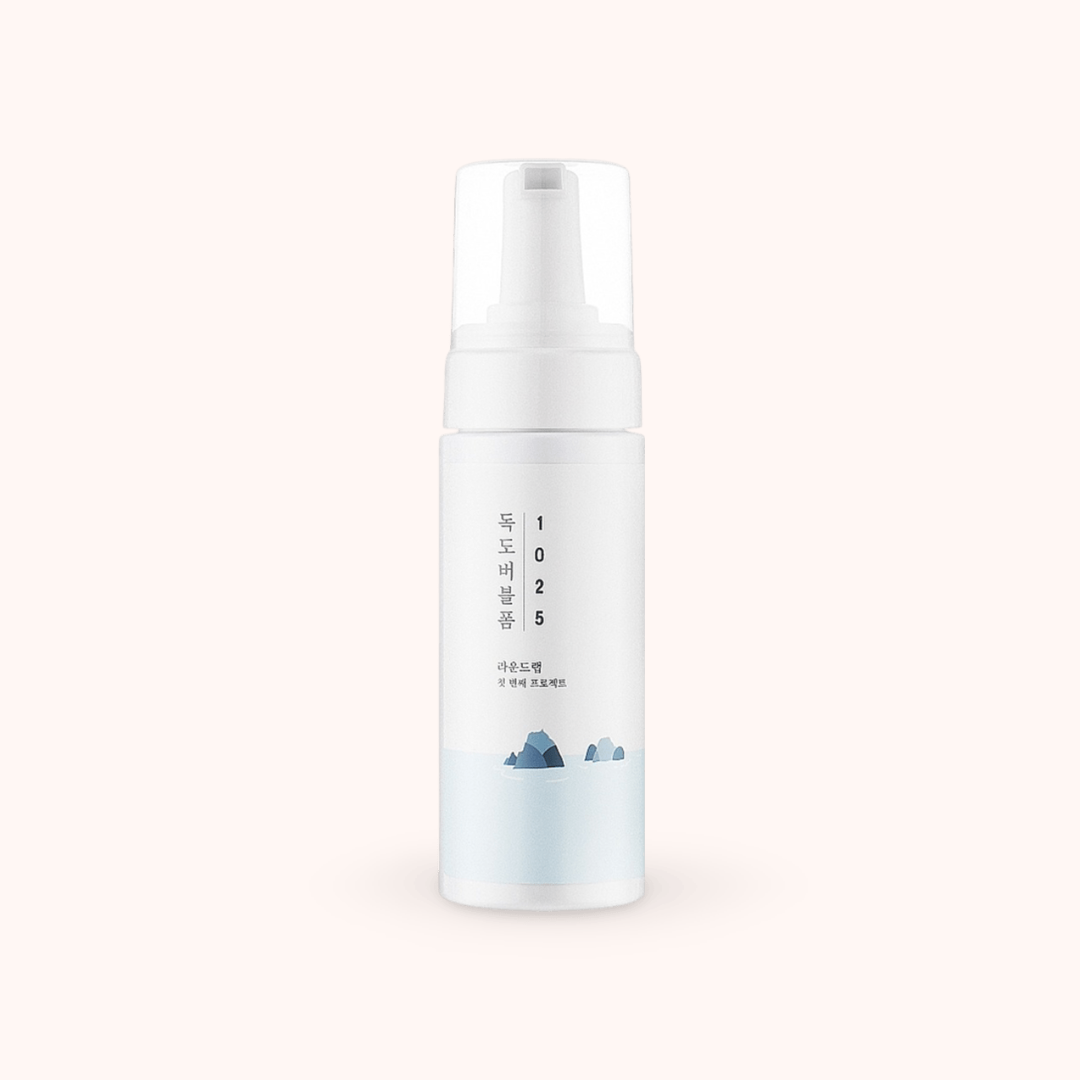 White skincare bottle with text and small graphics on a light gray background