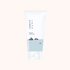 A white skincare tube with Korean text and a minimalist blue mountain-and-water illustration near the bottom, centered on a very light warm beige background.