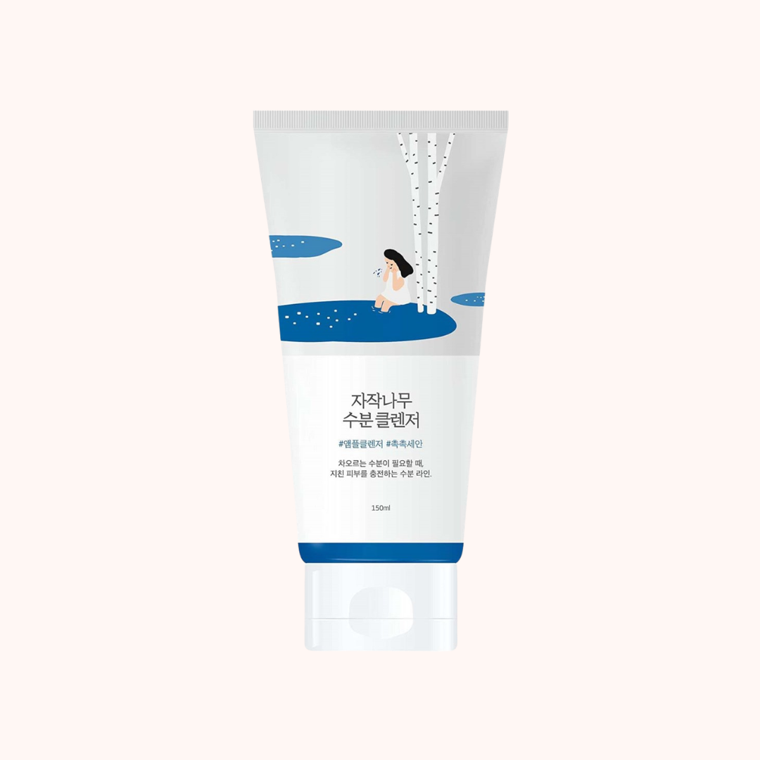 A 130ml squeeze tube of skincare product with Korean text, featuring a white and blue design with an illustration of a woman sitting by a waterfall, set against a solid pale pink background.