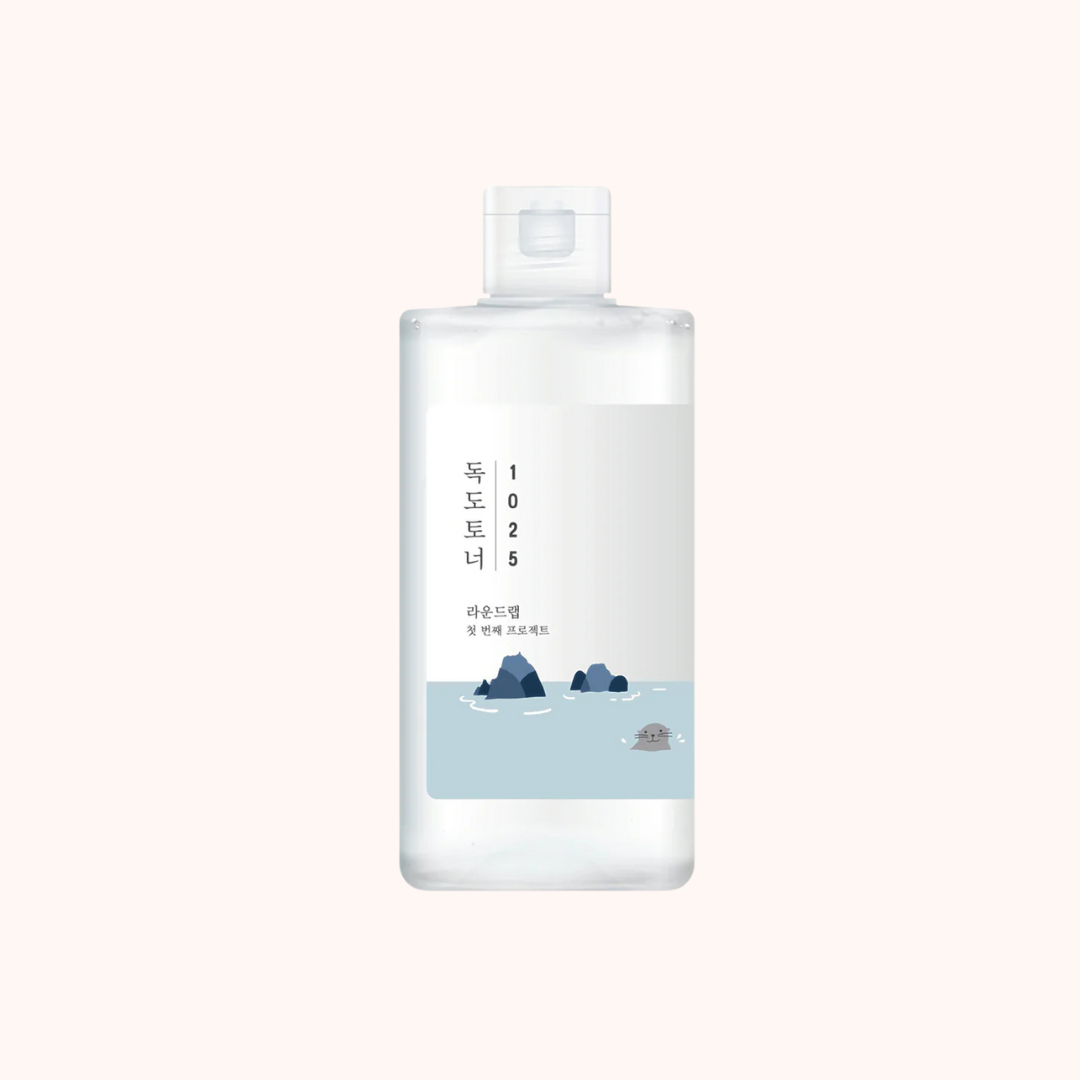 A bottle of Round Lab Dokdo 1025 Toner with a label featuring a blue and white design, indicating the product is a skin toner.