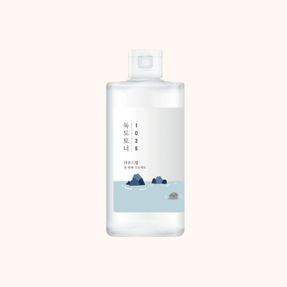 A bottle of Round Lab Dokdo 1025 Toner with a label featuring a blue and white design, indicating the product is a skin toner.