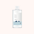 A bottle of Round Lab Dokdo 1025 Toner with a label featuring a blue and white design, indicating the product is a skin toner.