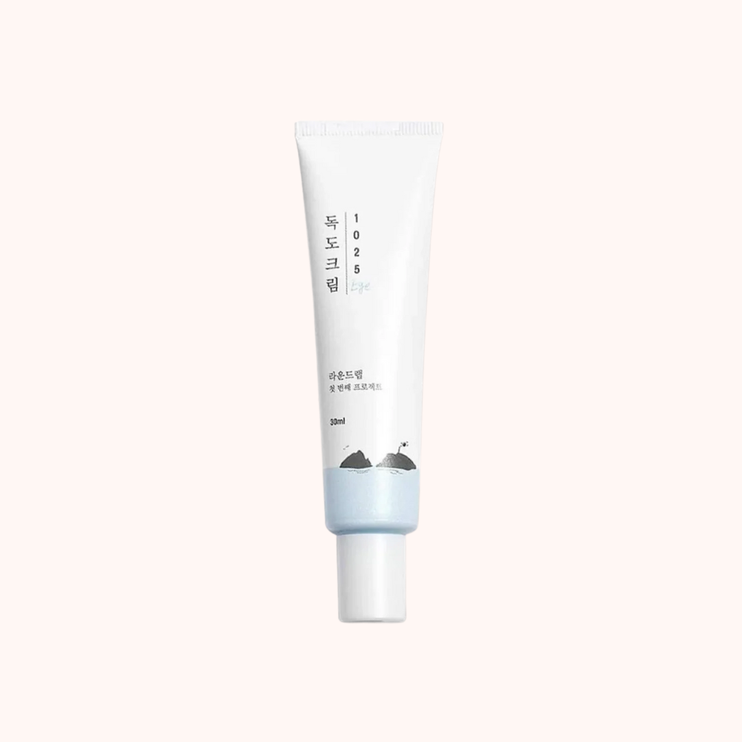 A tube of Round Lab Dokdo Moisturizing Eye Cream with a white and blue packaging, text in English is minimal.