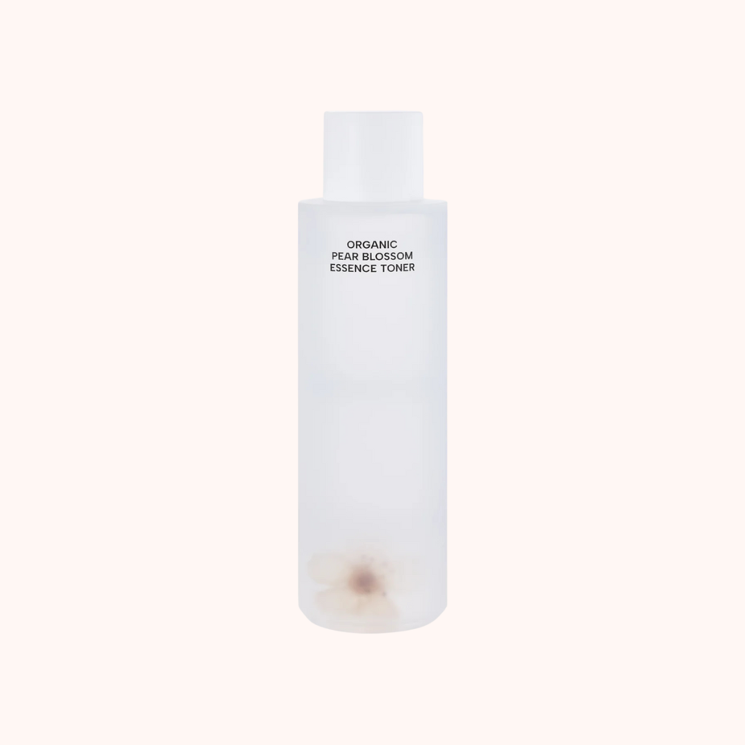 White bottle of organic pear blossom essence toner on a white background
