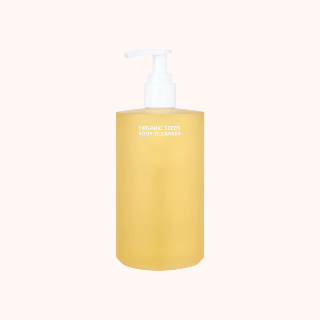 Yellow bottle of organic seed body cleanser on a white background
