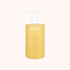 Yellow bottle of organic seed body cleanser on a white background