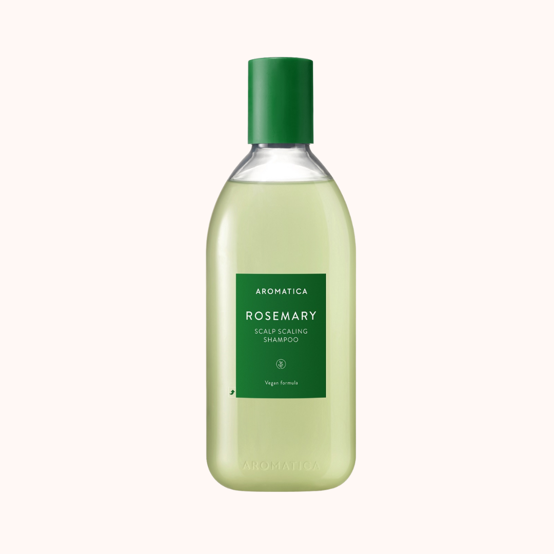 A bottle of Aromatica Rosemary Scalp Scaling Shampoo with a green cap and label, on a white background.