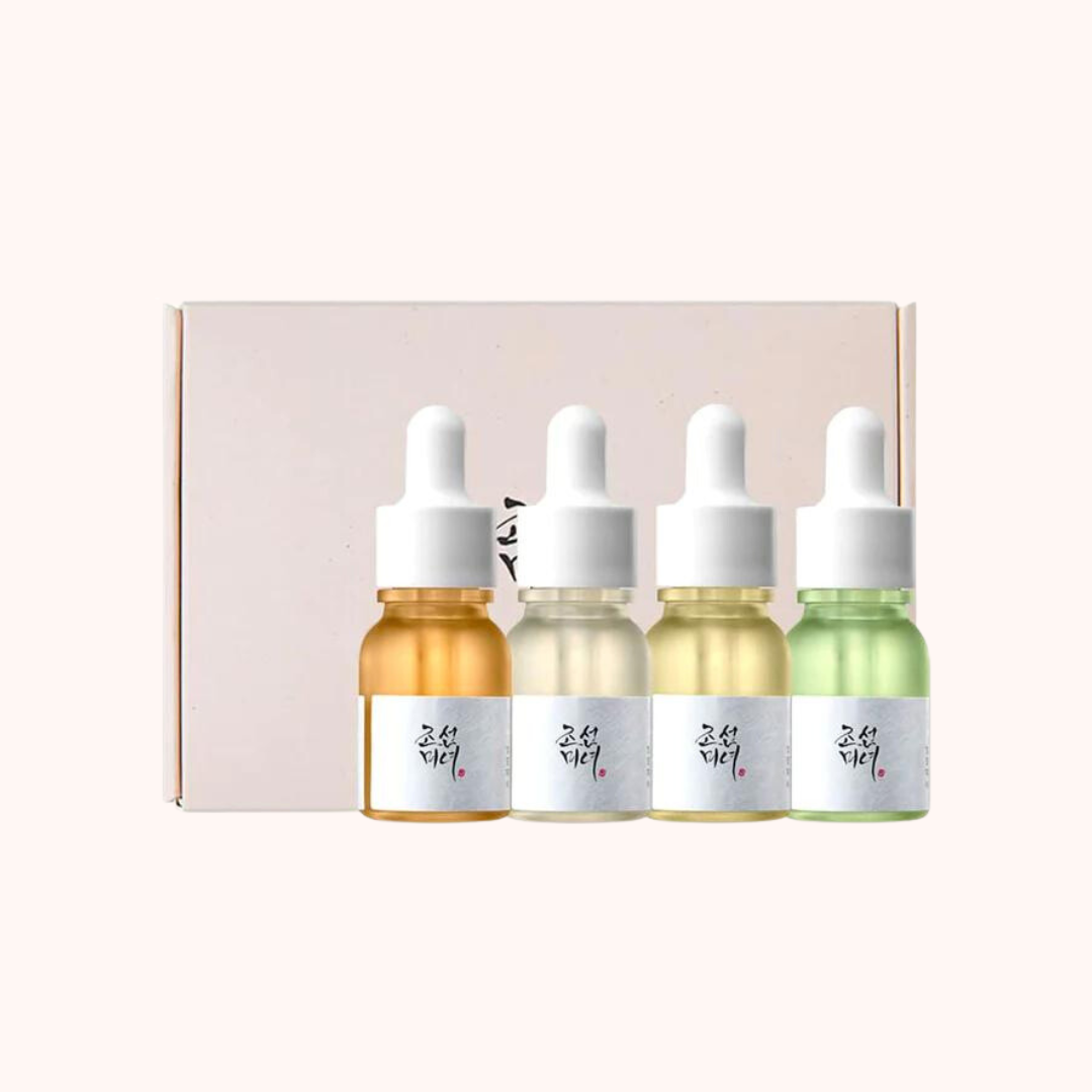 Four bottles of Beauty of Joseon Hanbang serums, each with a dropper, displayed in a box with a pink background.